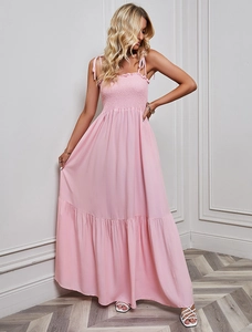 Detailed view of pink long dress featuring elastic smocked bodice and thin straps