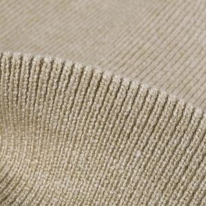 Close-up of beige ribbed knit fabric showing detailed texture of the warm winter beanie