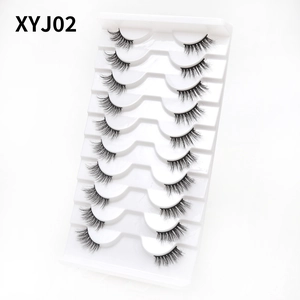 Detailed view of 10 pairs of black cat eye half eyelashes neatly set in a white tray