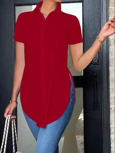 Detail of red short sleeve polo shirt featuring side slit hem and button-down front