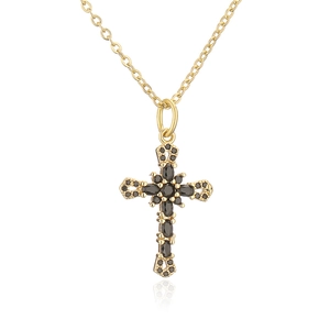 Close-up of 18K gold plated cross pendant with micro-pave black zircon on white background