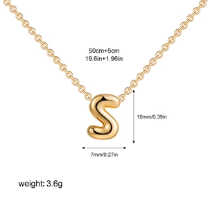 Macro shot of 3D bubble letter S pendant with dimensions and polished gold finish