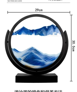 Blue and gold hourglass sand art landscape in circular frame with 29cm width dimensions