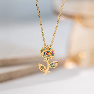 Elegant gold necklace with a rose pendant featuring pink, blue, and yellow zircons