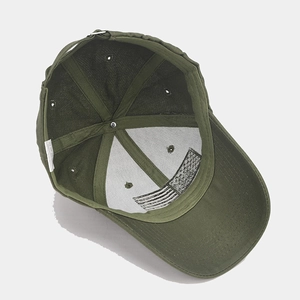 Detail view of military green baseball cap lining with American flag print and metal buckle