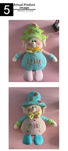 Detail of Christmas plush dolls with knitted hats and Merry Christmas embroidery text