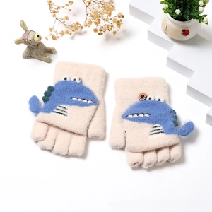 Close-up of pink knitted kids gloves with blue dinosaur pattern and convertible flap