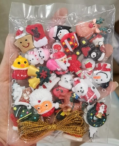 Detailed view of assorted resin Christmas ornaments with glitter and golden hanging strings