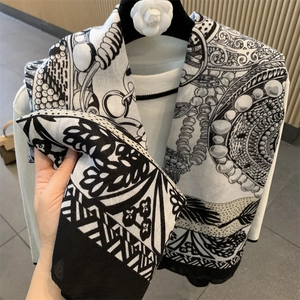 Elegant black and white silk scarf with floral patterns on camellia hanger