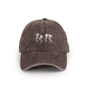 Detailed view of skull embroidery and washed cotton texture on vintage baseball cap