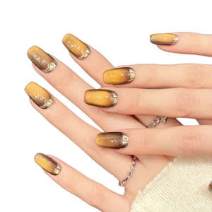 Caramel cat eye press-on nails with silver French mirror edges and glitter accents
