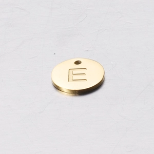 Close-up of a 12mm golden stainless steel round pendant with an engraved letter E detail