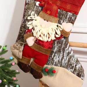 Festive red Christmas stocking featuring a 3D Santa Claus with pine needle decorations