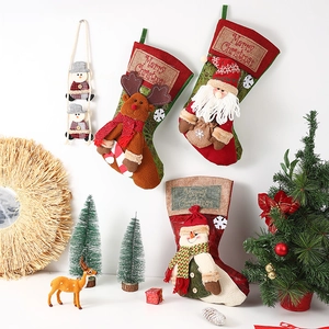 Vintage Christmas stockings featuring Santa, Snowman, and Reindeer 3D dolls