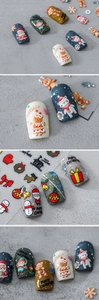 Close-up of 5D embossed Christmas nail stickers featuring Santa and gingerbread man patterns