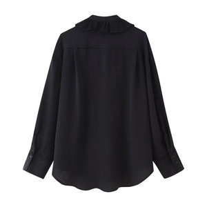 Rear view of black long sleeve shirt featuring ruffled collar and curved hemline details