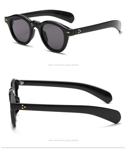 Detailed view of retro round sunglasses showing metal hinges and triple dot rivets