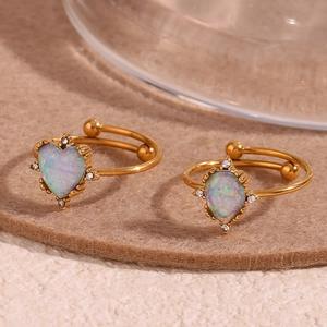 Detail of 18K gold-plated open rings with heart and water-drop shaped opal stones