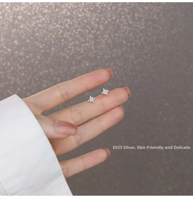 Close-up of S925 sterling silver star stud earrings with sparkling zircon crystals