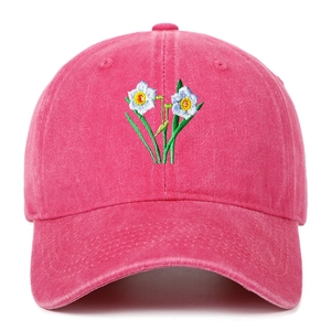 Close-up of daffodil floral embroidery on washed cotton distressed baseball cap