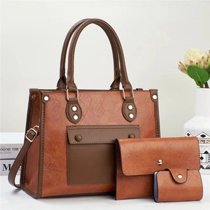 Three-piece vintage brown leather tote bag set including handbag and small purse
