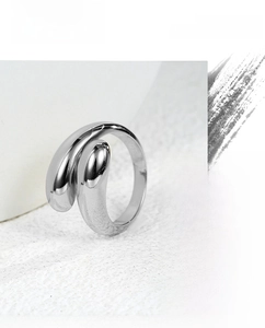 Detail view of polished silver water drop ring showing fluid metal design and open band