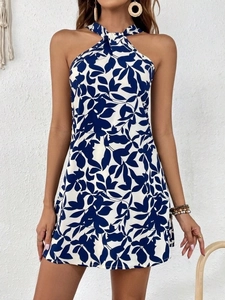 Detail of navy leaf print halter neck dress with ruffle hem and backless design