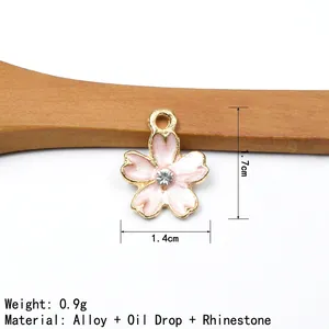 Detailed view of pink cherry blossom alloy pendant with rhinestone center and dimensions