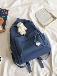 Minimalist navy blue high school backpack with cute plush bear pendant and rabbit badge