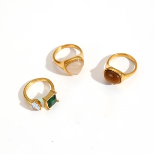Elegant gold stainless steel rings set with colorful zircon stones on white background