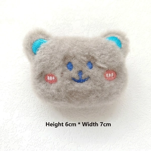 Detailed plush bear brooch with blue embroidery and 6cm x 7cm size dimensions