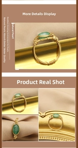 Detailed macro view of handmade gold wire wrapped ring with oval green gemstone on silk