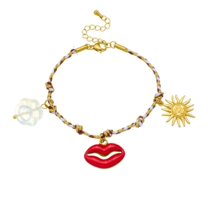 Bohemian braided cord bracelet with red lip, sun pendant and cat paw bead on white background