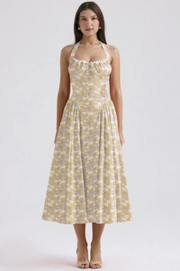 Close-up of yellow floral maxi dress showing halter neck lace trim and fabric texture