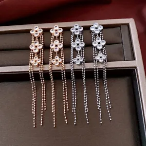 Elegant 18K gold plated clover earrings with long beaded tassels in gold and silver