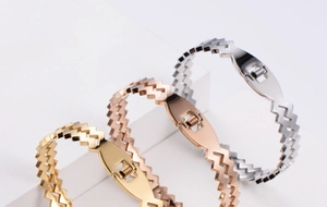 Detail view of gold, rose gold and silver zigzag metal bracelets with spring clasp