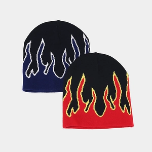 Close-up of knit beanies featuring dynamic flame patterns in blue and red flame colors