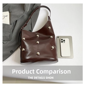 Close-up of vintage burgundy bucket bag featuring six silver rivets and leather texture