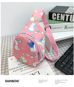 Detail of pink kids crossbody bag with vibrant unicorn and rainbow patterns and zipper pockets
