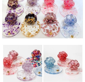 Detailed view of cat paw resin crafts with natural crystals and glitter on white base