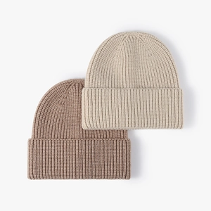 Classic ribbed knit beanie hats in cream and light brown for winter warmth and style