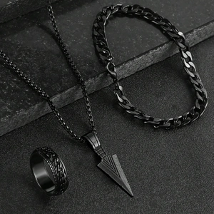 Detail of matte black stainless steel jewelry set with arrow pendant and cuban chain