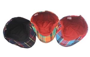 Detail view of colorful plaid beret hats showing polyester lining and wash labels