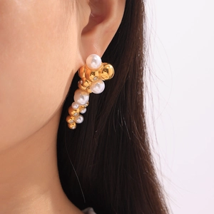 Elegant French-style gold pearl earrings with zircon cluster for women on model