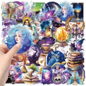 Close-up of waterproof magic planet stickers with crystal ball and owl for scrapbooking