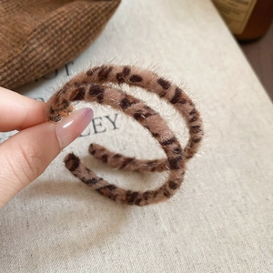 Close-up of leopard print faux fur round hoop earrings with soft plush texture for women