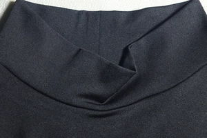 Detailed view of the black mock neck and fine knit texture of the bodycon mini dress
