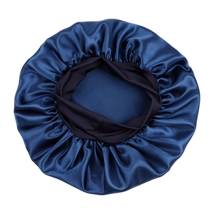 Detail of dark blue satin bonnet with wide elastic band and smooth silk-like texture