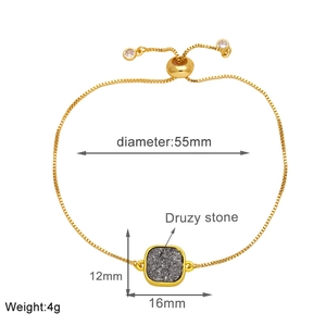 Detail of gold box chain bracelet with gray druzy stone and adjustable slider closure