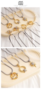 Detailed view of zircon-inlaid pendants with heart and star patterns on silver snake chains